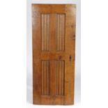 A 16th century oak linenfold panelled door, circa 1520-50 Of four narrow panels, within broad rails,