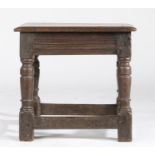 A Charles I oak low stool, circa 1640 Having a rectangular seat with triple-reeded edge, multiple