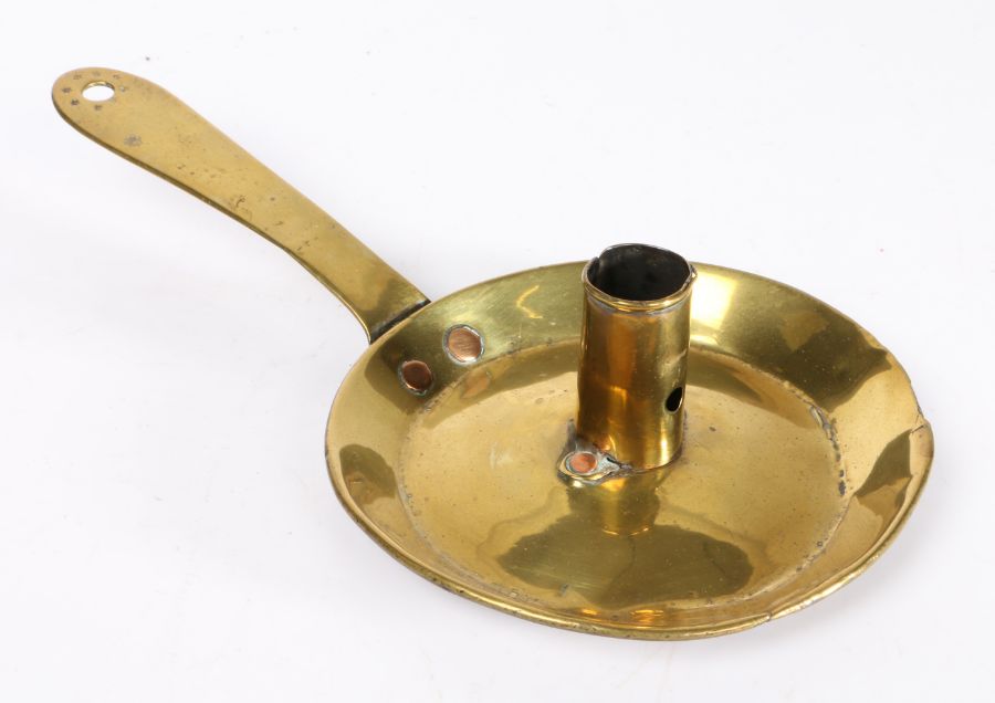 An early to mid-18th century brass chamberstick, probably English, circa 1720-50 The pan with rolled