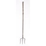 A steel toasting fork, English, circa 1800 Having three staggered tines, a slender rectangular