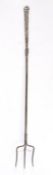 A steel toasting fork, English, circa 1800 Having three staggered tines, a slender rectangular