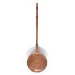 A copper warming pan, with fruitwood handle, circa 1750-1800 Having a scroll-pierced and engraved