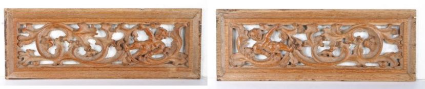 A pair of oak carved and pierced panels, circa 1500 Each deeply carved with a cherub resting amongst