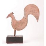 An early 20th century sheet iron cockerel weathervane With curved body, prominent tail 'feather' and