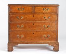 A George III oak chest of drawers, circa 1790 Of slender proportions, the rectangular boarded top