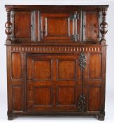 A Charles II oak boarded and panelled court cupboard, West Country, circa 1680 The boarded top