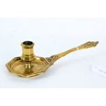 A cast brass chamberstick, French Having an octagonal socket and pan, mask terminal to handle,