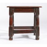 A Charles I oak low joint stool, circa 1640 Having a thin seat board with ovolo-moulded edge,