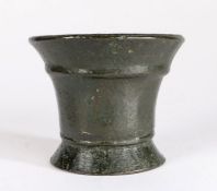 An early small 17th century bronze-alloy mortar, English Having a cord below the flared rim, on a