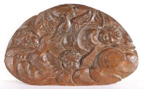 A mid-17th century carved oak panel, circa 1650 Designed with three cherub masks, within a storm