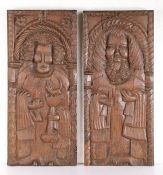 A pair of 16th century oak naively carved panels, circa 1500 Each designed as a standing saint,