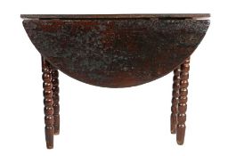 A rare Charles II oak gateleg table, Cumbria, circa 1680 The circular drop-leaf top on ball turned