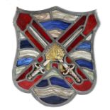 A stained glass panel, of shield shape, designed with crossed swords, 24cm wide, 28cm high