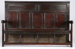 A rare Charles II oak high-back settle, circa 1670 The rectangular back with dentil-moulded top