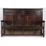 A rare Charles II oak high-back settle, circa 1670 The rectangular back with dentil-moulded top