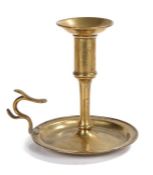 An unusual George III brass chamberstick, circa 1770 Having a tall socket with large flared rim