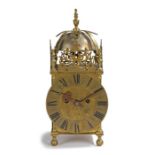 An 18th Century and later brass lantern clock The bell held under a frame, with dolphin pierced