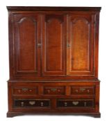 A George III oak press cupboard, circa 1800 With central arched fielded panel, flanked by