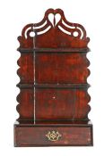 A George III stained pine spoon rack, circa 1790 The arched backplate surmounted by a fretwork