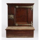 A 17th century oak prie dieu, French Having a single panelled cupboard door, enclosing two