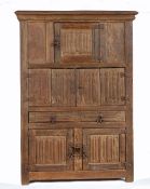 A small and interesting oak linenfold-carved cupboard  In the 16th century manner, having a deep