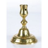 An early 18th century brass candlestick, Dutch, circa 1720 The seamed tulip-shaped socket with