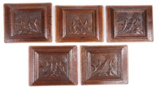 A group of five carved oak framed panels, Flemish, circa 1600 All designed with a bird, standing