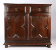 An uncommon Charles II joined oak enclosed cupboard, circa 1670 Having a long drawer, with paired