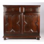 An uncommon Charles II joined oak enclosed cupboard, circa 1670 Having a long drawer, with paired