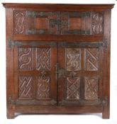 A large 16th century oak parchemin-carved cupboard, German, circa 1540 Having a central pair of