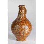 A 17th century bellarmine jug, German, probably Rhenish Of ovoid shape, with mottled tigerware