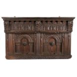 An Elizabeth I oak overmantle/headboard, West Country, circa 1590 With leafy-carved cornice and