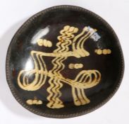 A George III slip-decorated earthenware dish, Staffordshire, circa 1780 Of 'circular' form, with