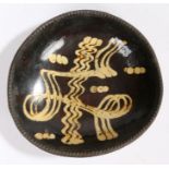 A George III slip-decorated earthenware dish, Staffordshire, circa 1780 Of 'circular' form, with