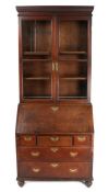 A George III oak and glazed bureau bookcase With two glazed cupboard doors enclosing two