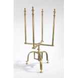 A rare George II brass revolving plate warmer and stand, circa 1750 Having four long finial-topped