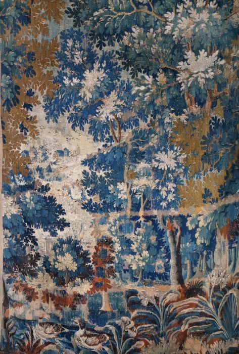 A 17th century verdure tapestry panel, Flemish Woven in coloured wools with silk highlights,