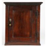 A George III oak mural cupboard, circa 1760 Having a single-panelled cupboard door, enclosing one