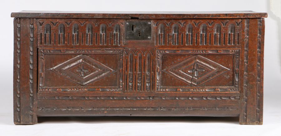 An Elizabeth I oak coffer, circa 1600 The boarded lid with square-edge, the front with two slender