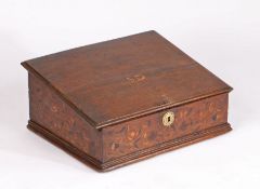 A Charles II oak and marquetry-inlaid oak desk box, circa 1660 The sloping boarded lid centred by