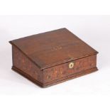 A Charles II oak and marquetry-inlaid oak desk box, circa 1660 The sloping boarded lid centred by