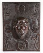 A 17th century carved oak panel Carved with a stylised flowerhead filled quatrefoil against a