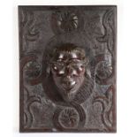 A 17th century carved oak panel Carved with a stylised flowerhead filled quatrefoil against a