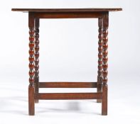 A small Queen Anne oak centre table, circa 1710 Having a twin-boarded tray-top with applied half-