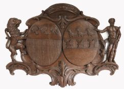 A large mid-18th century carved oak armorial panel Designed with two coats of arms, with a Rococo