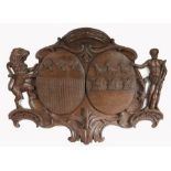 A large mid-18th century carved oak armorial panel Designed with two coats of arms, with a Rococo
