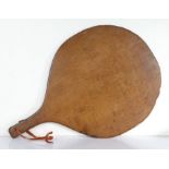 A 19th century oak pie peel or spittle, English Of circular paddle form, the short handle pierced