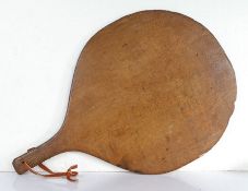 A 19th century oak pie peel or spittle, English Of circular paddle form, the short handle pierced