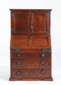 A George III elm miniature bureau cabinet, circa 1800-20 Having a pair of boarded doors, with