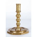 A late 17th century brass candlestick, Spanish With linear-incised cylindrical socket, the stem with